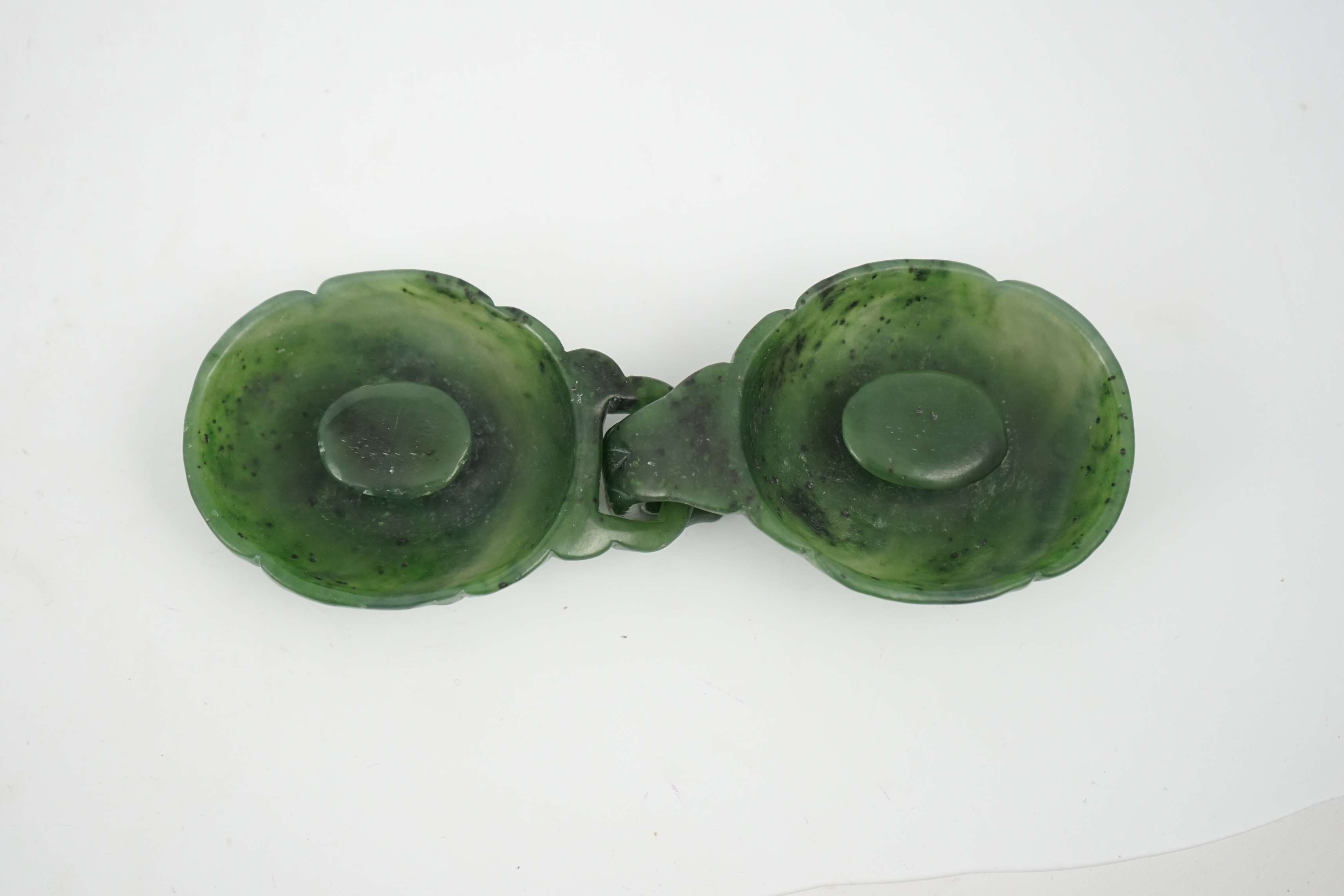 A Chinese spinach green jade two-piece belt buckle, 18th/19th century